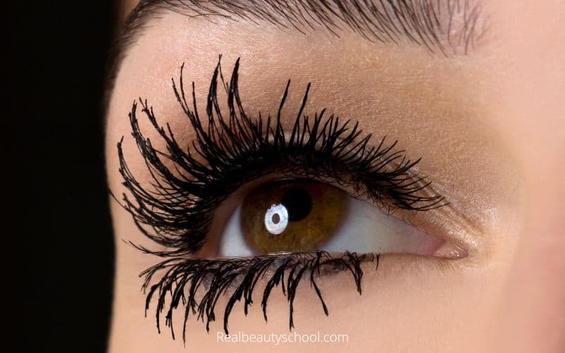 woman wearing too much mascara with clumps in a spider legs style