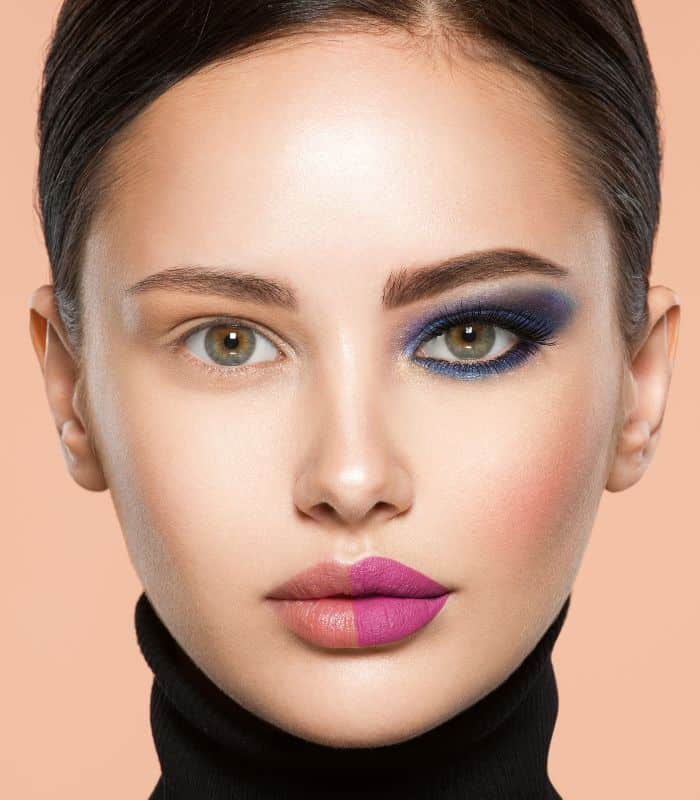 woman wearing blue eyeshadow and pink lips