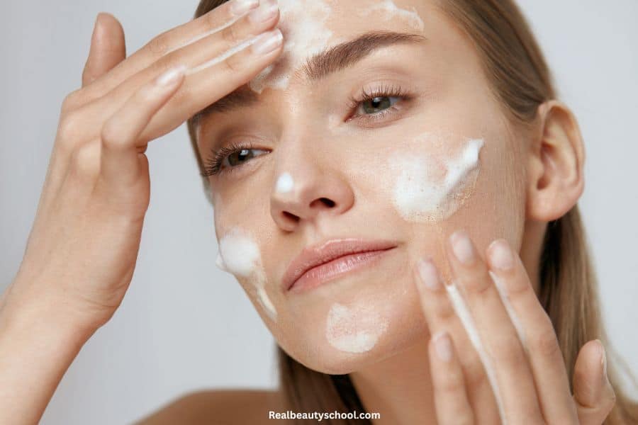 woman washing her face with a foaming cleanser