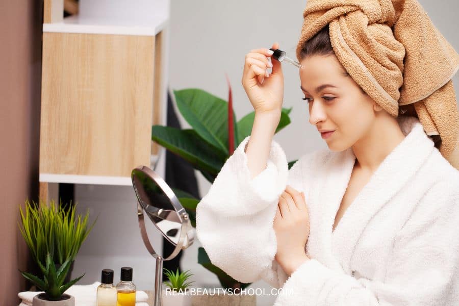 woman applying niacinamide serum