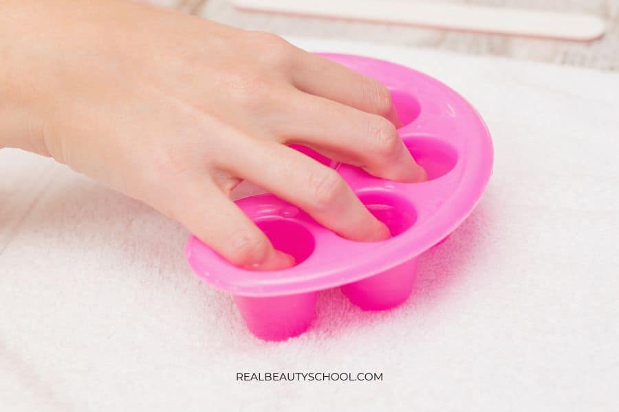 soaking the nails in acetone to remove gel polish