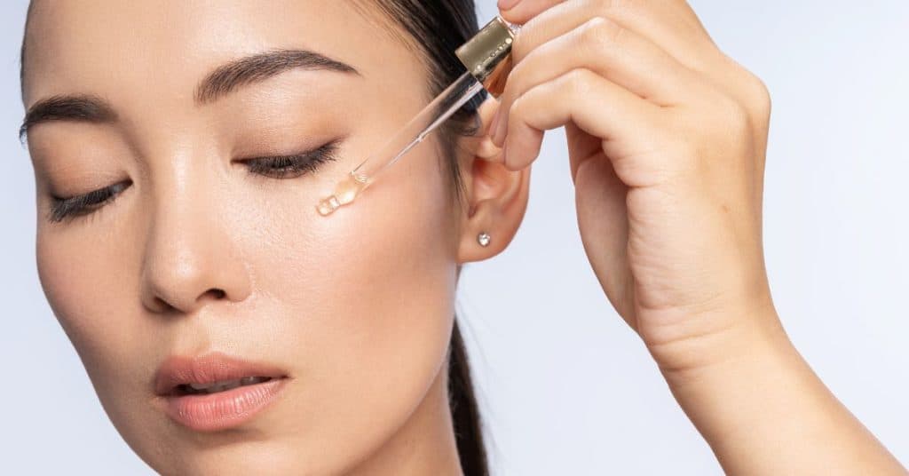 woman applying a the ordinary serum