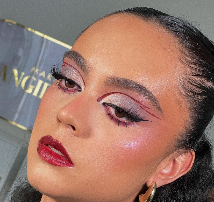 Glossy red lips with flawless foundation and highlighter for a bold concert glam style